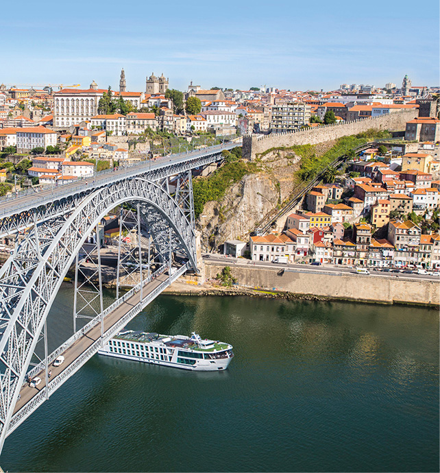 Star-Ship Emerald Radiance sails through the heart of Porto in Portugal, passing under the Dom Luís Bridge