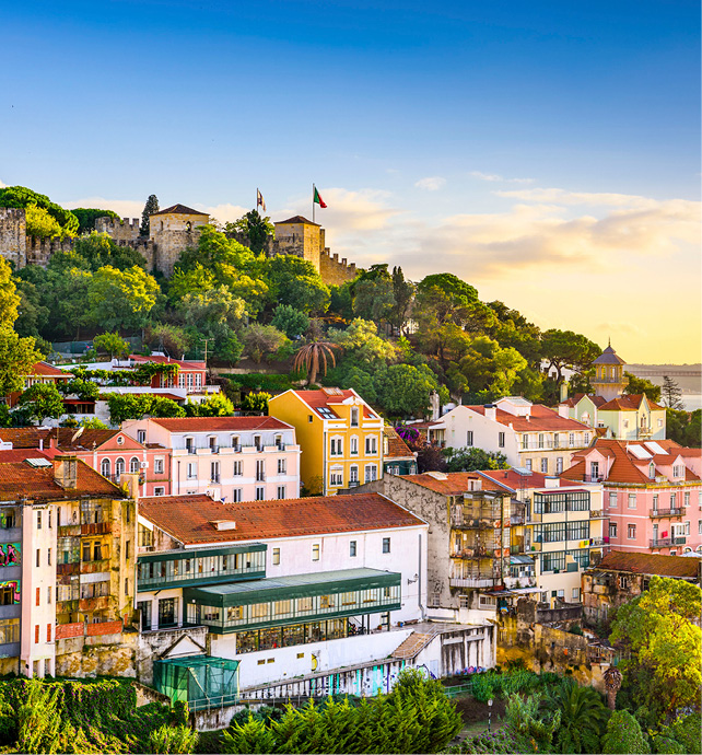  A bright blue sky is seen over Lisbon’s colourful buildings with the 25th April Bridge seen in the background.