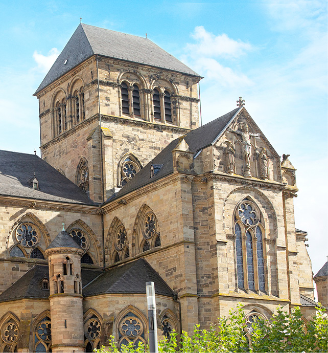 A close-up of Trier Cathedral, including its ornate windows, towers and façade 