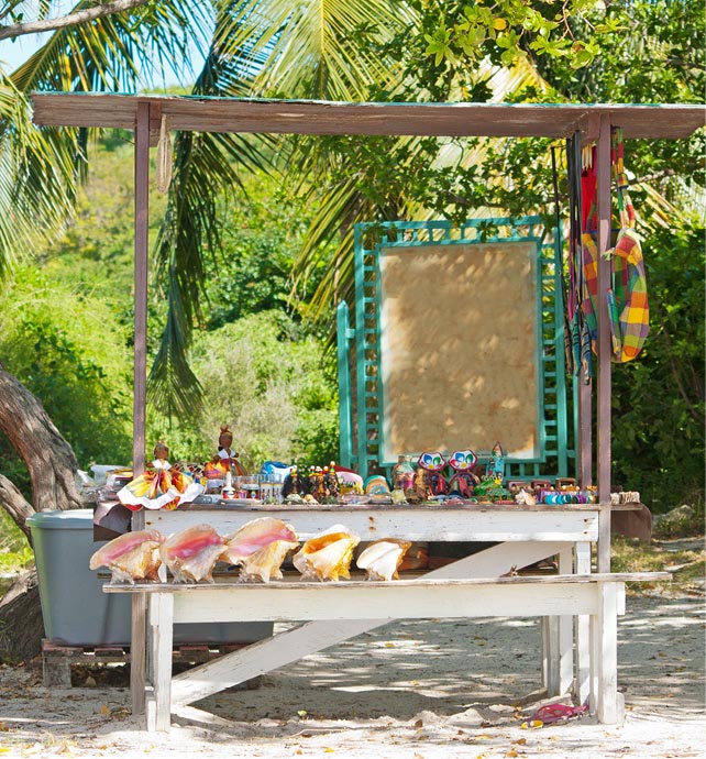 Quaint wooden stall on a beach in Antigua selling arts, crafts and shells